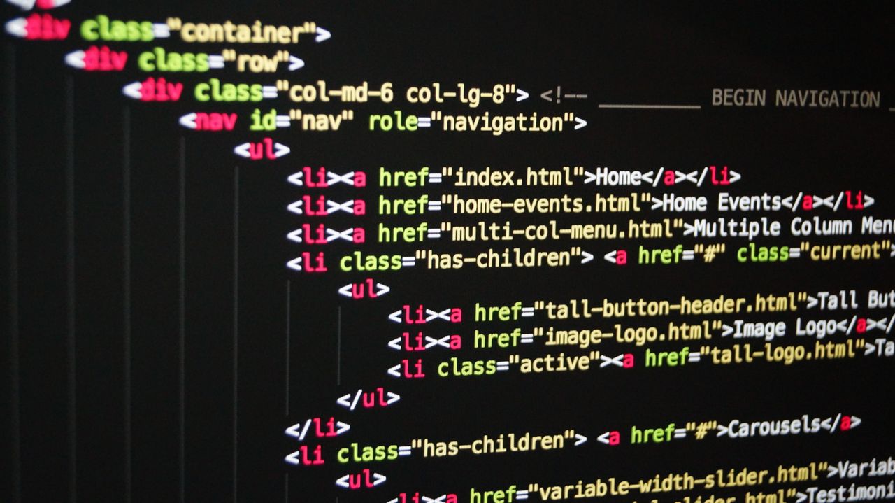 A close-up view of vivid HTML code shown on a computer monitor, highlighting web development and programming.